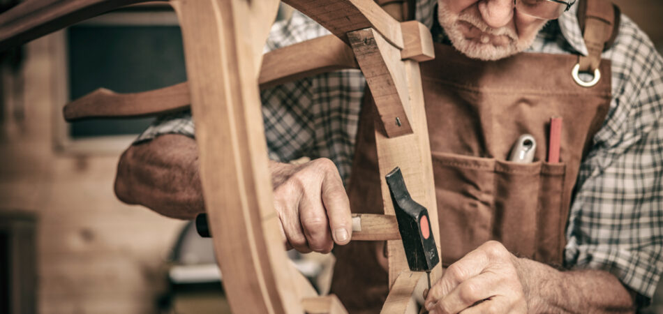Elderly,carpenter,builds,a,classic,style,chair